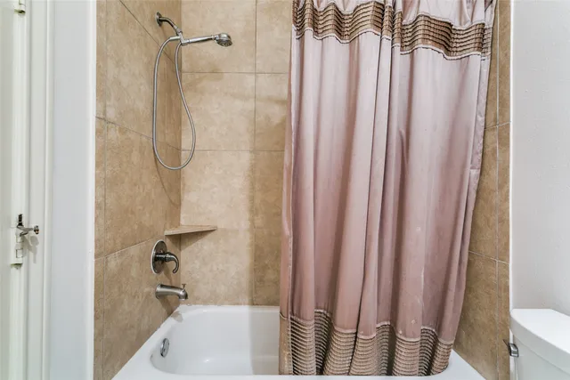 a bathroom with a shower and a tub
