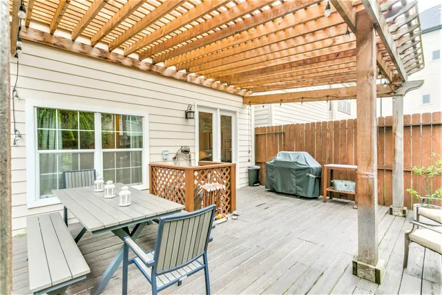 a view of a deck with table and chairs and wooden floor