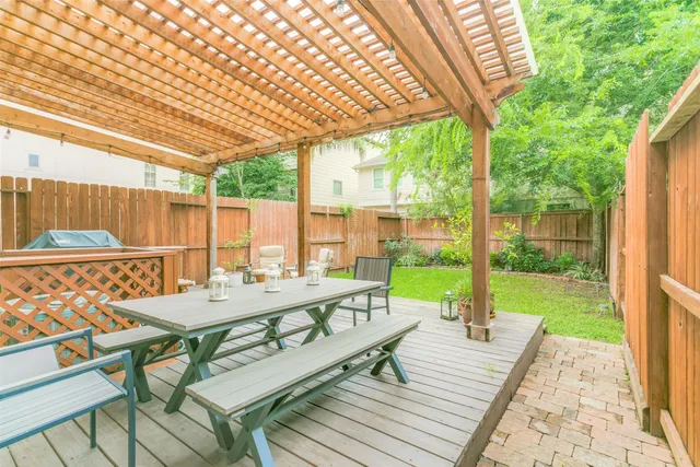 a view of a patio with a table chairs and a backyard