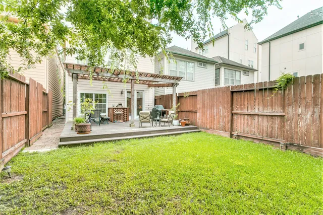 a view of a patio with couches chairs and a big yard