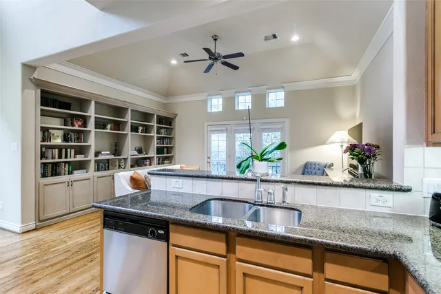a kitchen with a sink and a potted plant