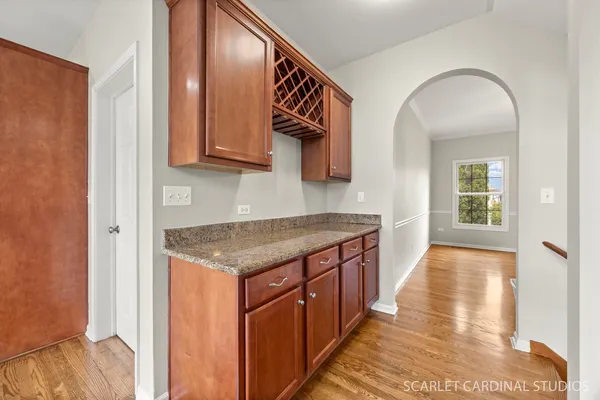 a dining room filled chandelier and wooden floor