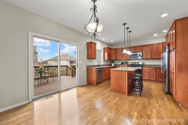 a kitchen with stainless steel appliances granite countertop a sink a stove and a refrigerator