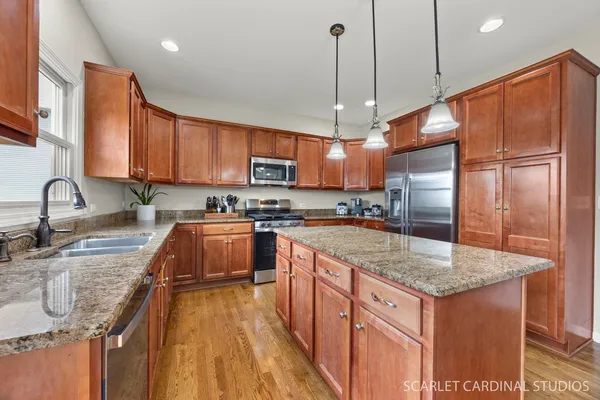 a kitchen with cabinets a sink dining table and chairs