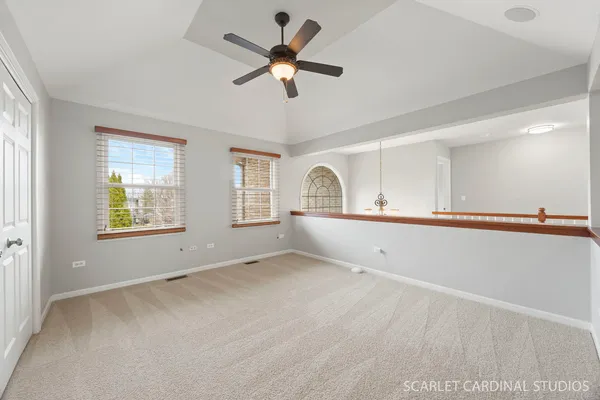 a bedroom with a bed a chandelier and a window