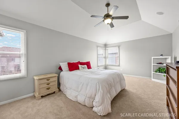 a bedroom with a large bed and a flat screen tv