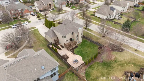 an aerial view of a residential houses with outdoor space