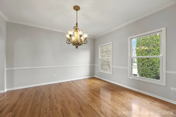 a view of a room with a large window and a chandelier