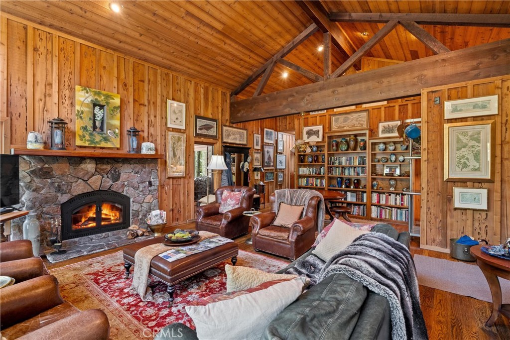 7501 Maddrill Lane Butte Meadows, CA 95942 - Photo 14 of 70 a living room with furniture a fireplace and a floor to ceiling window