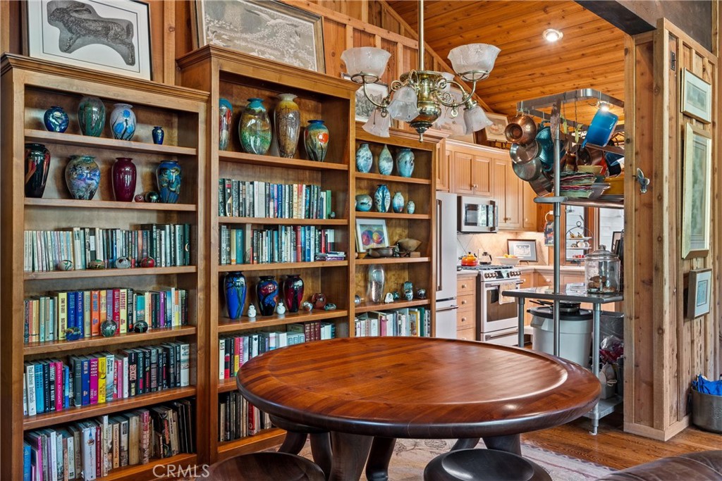 7501 Maddrill Lane Butte Meadows, CA 95942 - Photo 16 of 70 a view of a dining room with furniture and a book shelf
