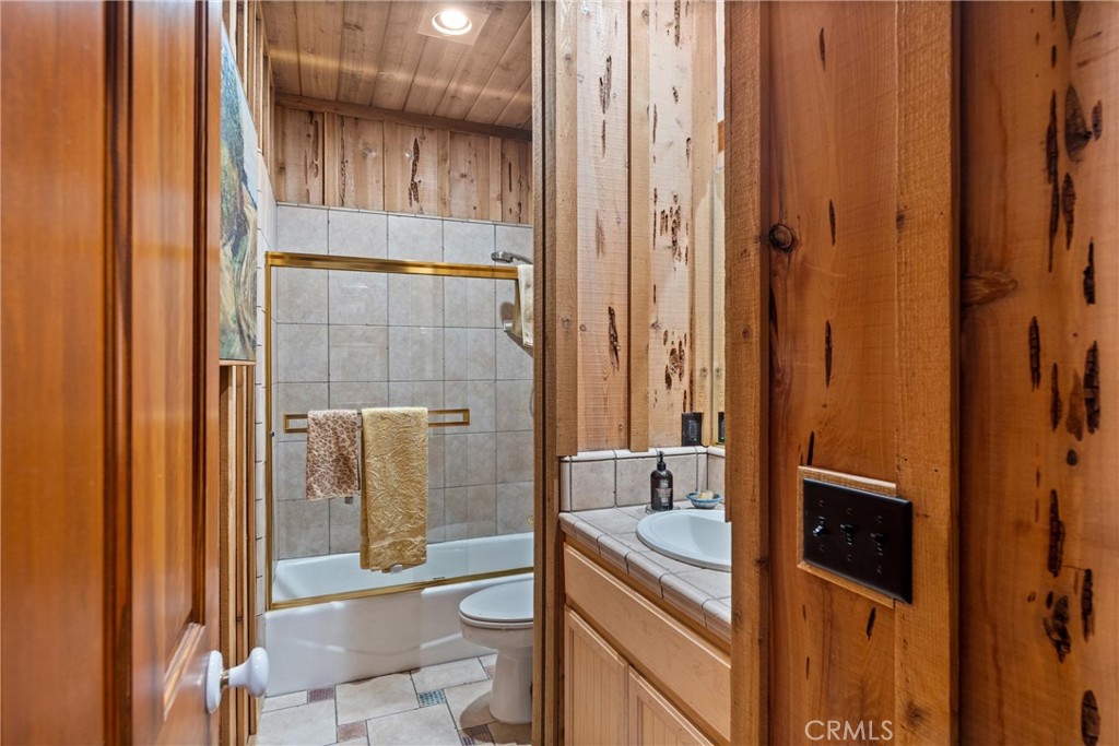 7501 Maddrill Lane Butte Meadows, CA 95942 - Photo 21 of 70 a bathroom with a granite countertop sink a toilet and shower