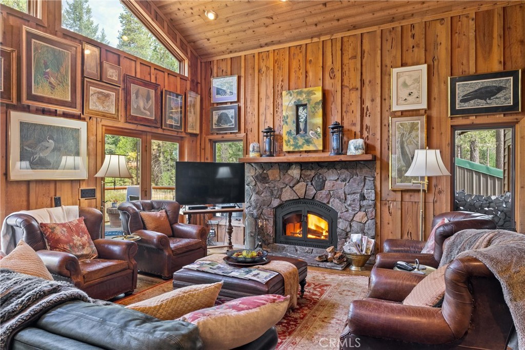 7501 Maddrill Lane Butte Meadows, CA 95942 - Photo 10 of 70 a living room with furniture a fireplace and a flat screen tv