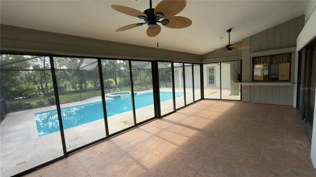 a view of hallway with a ceiling fan