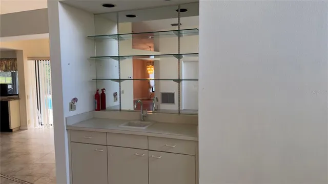 a kitchen with cabinets and a refrigerator