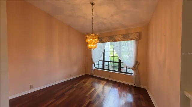 a view of a room with wooden floor and fan