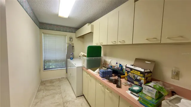 a view of a kitchen with refrigerator and a stove top oven