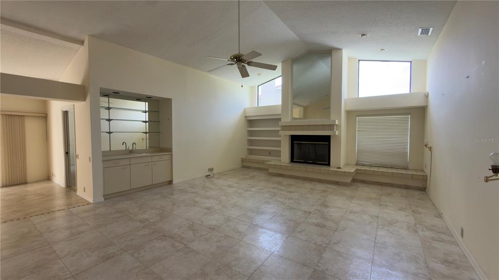 5040 Pinelake Road Wesley Chapel, FL 33543 - Photo 37 of 38 an empty room with furniture and a fireplace