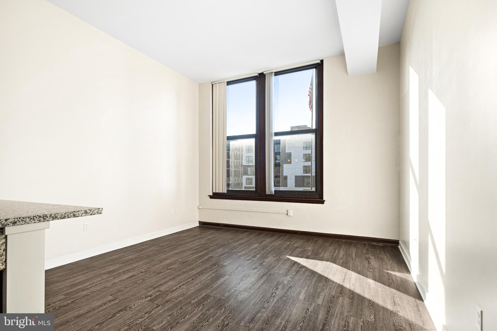 523 North Broad Street, Unit P1 Philadelphia, PA 19123 - Photo 15 of 37 a view of an empty room with wooden floor and a window