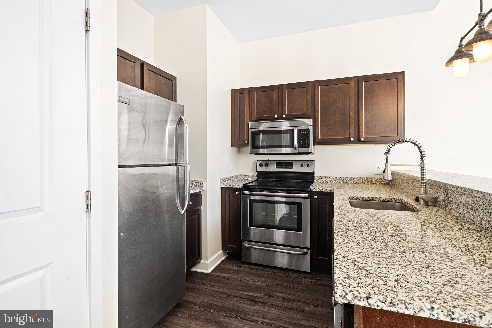 523 North Broad Street, Unit P1 Philadelphia, PA 19123 - Photo 17 of 37 a kitchen with stainless steel appliances granite countertop a refrigerator and a stove top oven