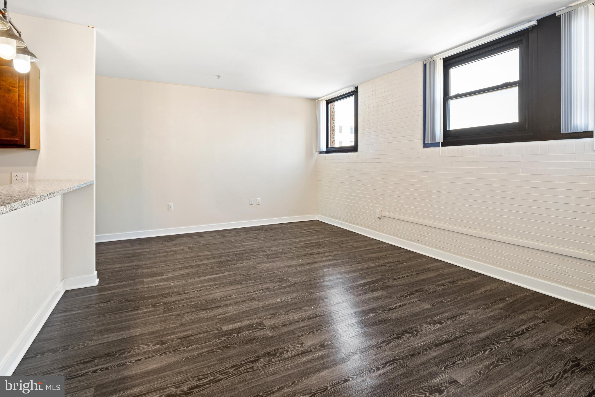 523 North Broad Street, Unit P1 Philadelphia, PA 19123 - Photo 26 of 37 a view of an empty room with wooden floor and a flat screen tv