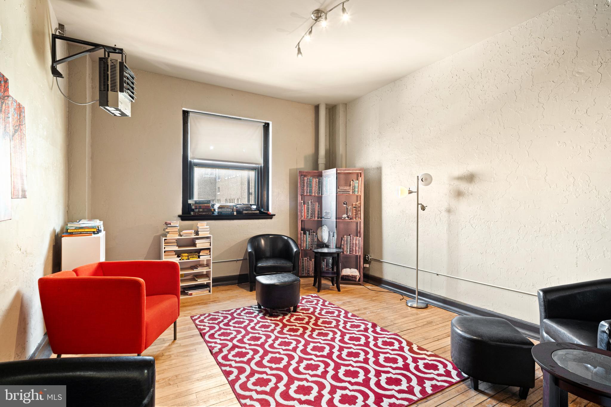523 North Broad Street, Unit P1 Philadelphia, PA 19123 - Photo 35 of 37 a living room with furniture a rug and a window