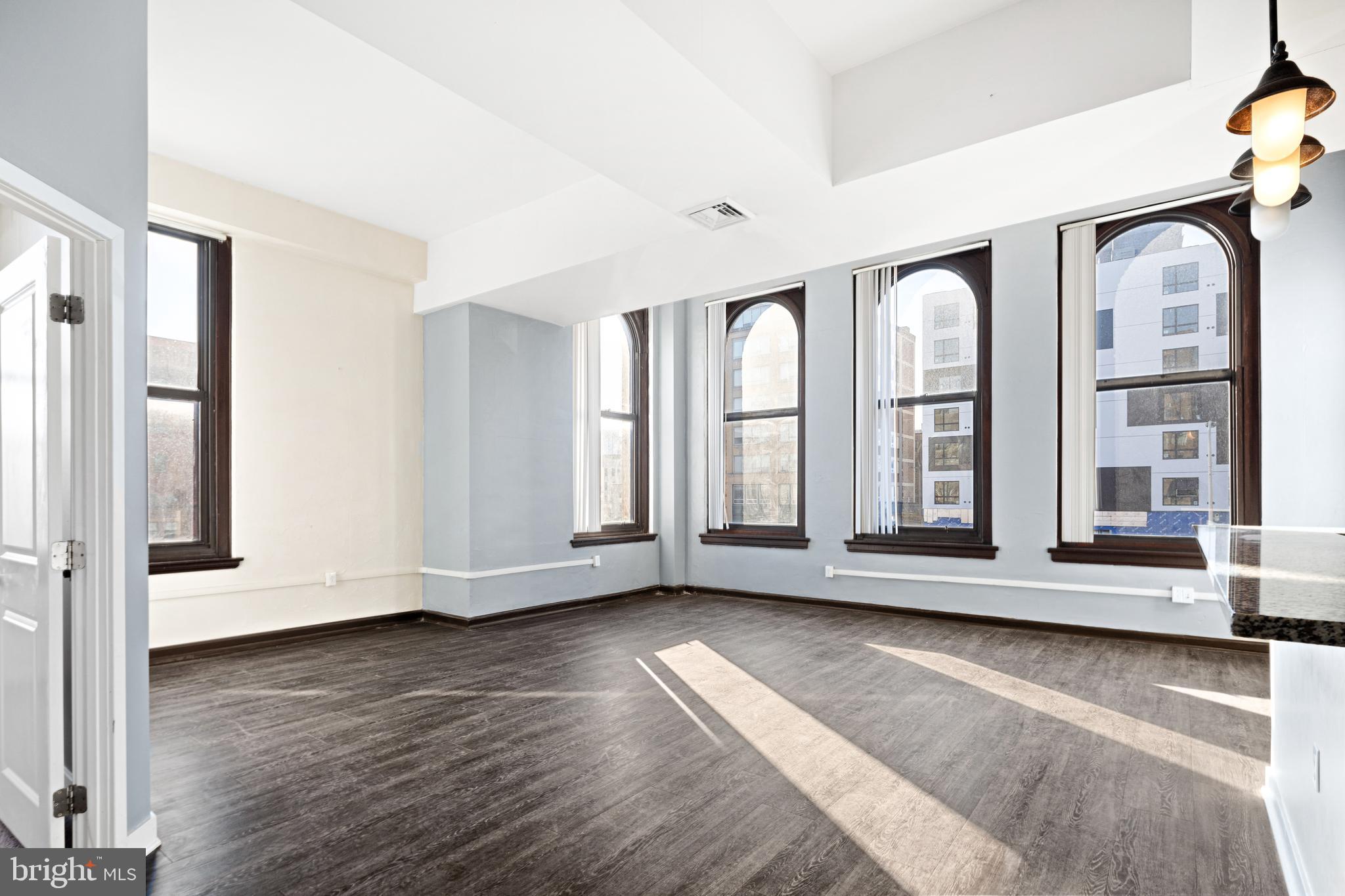 523 North Broad Street, Unit P1 Philadelphia, PA 19123 - Photo 7 of 37 a view of an empty room with wooden floor and a window