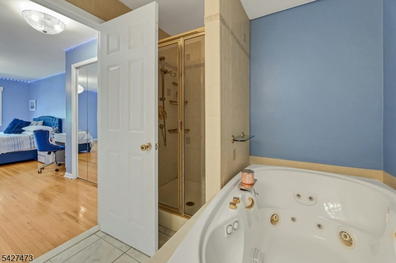 100 Easedale Road, Unit 100 Wayne, NJ 07470 - Photo 25 of 43 a bathroom with a tub and a view of living room