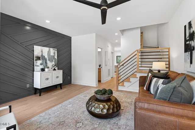 a living room with furniture and a wooden floor