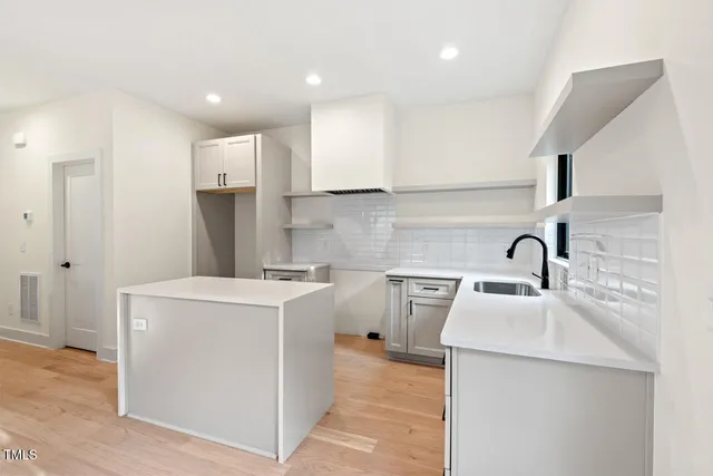 a kitchen with a sink a stove and a refrigerator