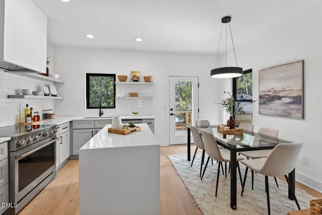 a kitchen with a table chairs stove and microwave