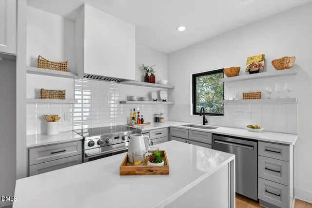 a kitchen with a sink a stove and cabinets