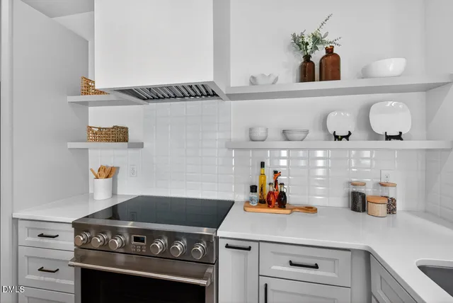 a kitchen with a stove and cabinets