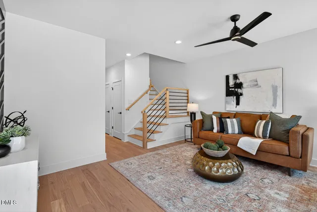 a living room with furniture and a wooden floor