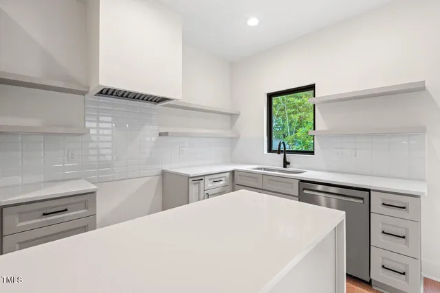 a kitchen with a white cabinets and white appliances