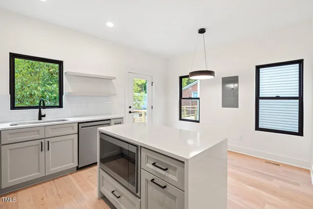 a kitchen with a sink stove and cabinets