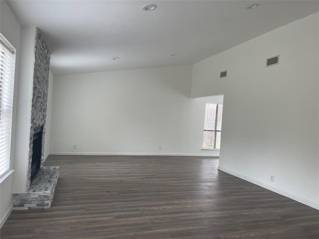 3 Ridge Drive Hickory Creek, TX 75065 - Photo 7 of 20 a view of an empty room with wooden floor and a window