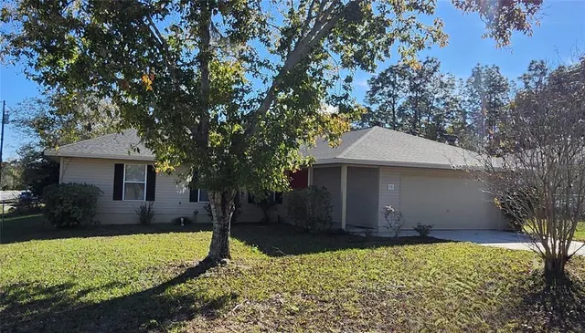 a front view of house with yard and trees