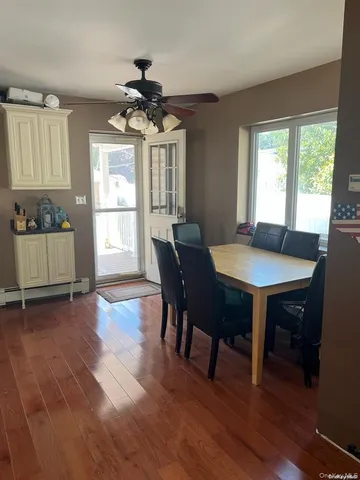 a view of a dining room with furniture window and wooden floor