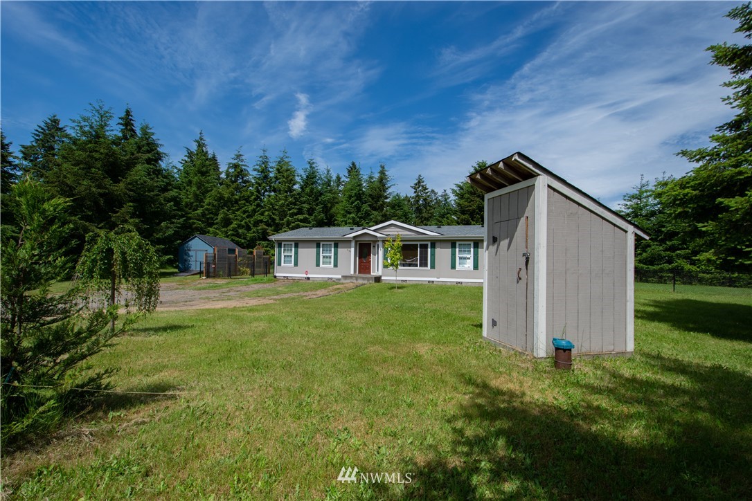 9134 176th Avenue Southwest Rochester, WA 98579 - Photo 2 of 24 a front view of a house with garden