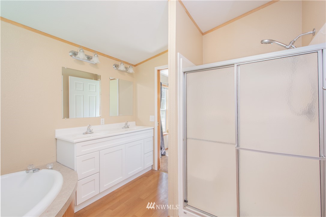 9134 176th Avenue Southwest Rochester, WA 98579 - Photo 19 of 24 a bathroom with a sink a mirror and a shower