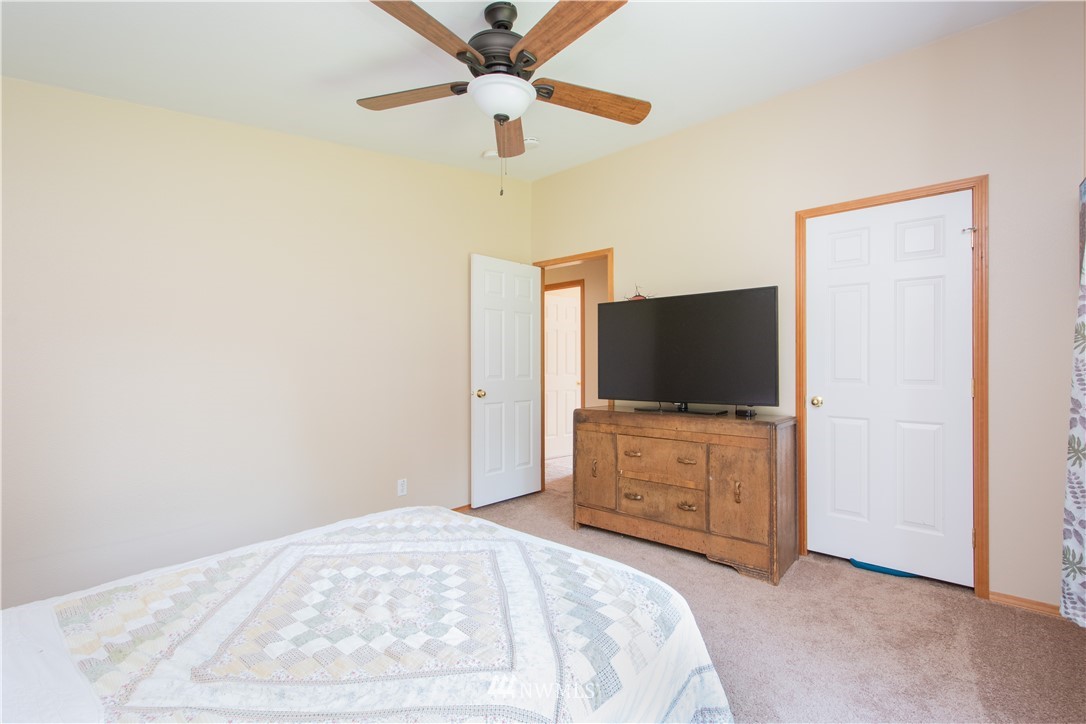 9134 176th Avenue Southwest Rochester, WA 98579 - Photo 22 of 24 a bedroom with a bed and a flat screen tv