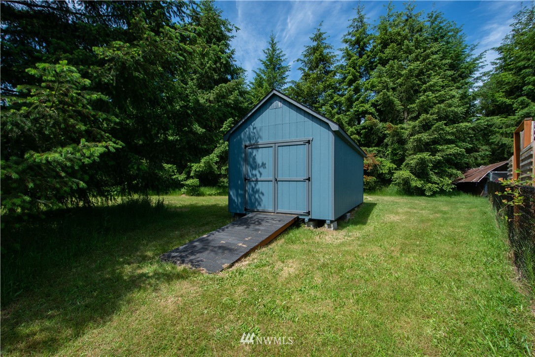 9134 176th Avenue Southwest Rochester, WA 98579 - Photo 7 of 24 a wooden house with a yard