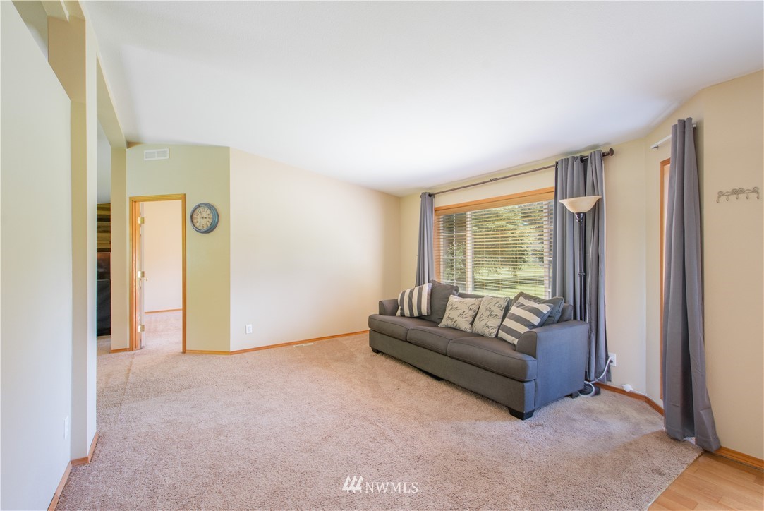 9134 176th Avenue Southwest Rochester, WA 98579 - Photo 9 of 24 a living room with furniture and a large window