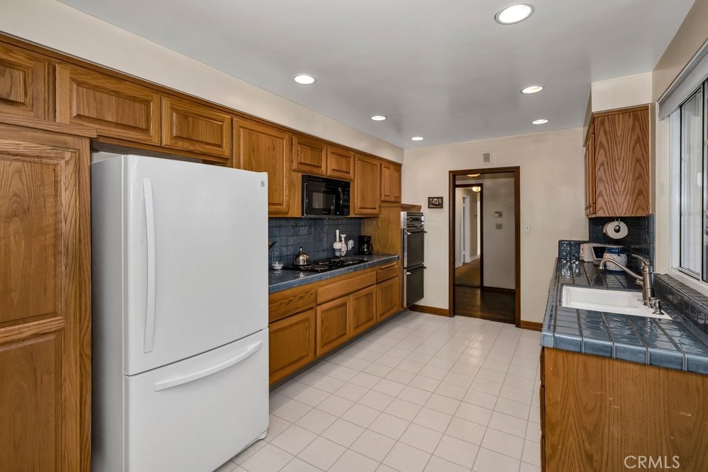9916 Bothwell Road Northridge, CA 91324 - Photo 13 of 41 a kitchen with granite countertop a refrigerator and a sink