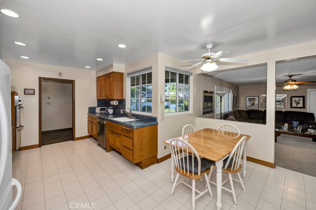 9916 Bothwell Road Northridge, CA 91324 - Photo 14 of 41 a kitchen with stainless steel appliances kitchen island granite countertop a table and chairs in it