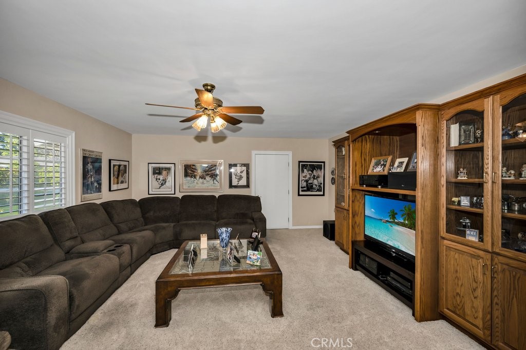 9916 Bothwell Road Northridge, CA 91324 - Photo 17 of 41 a living room with furniture a ceiling fan and a window