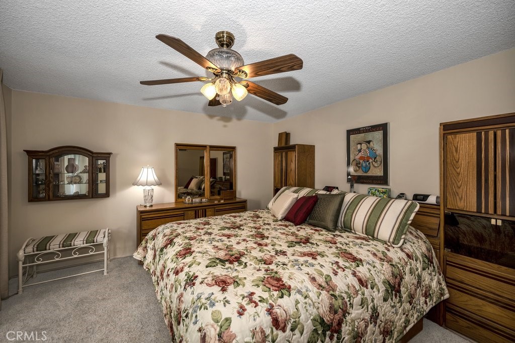 9916 Bothwell Road Northridge, CA 91324 - Photo 22 of 41 a bedroom with a bed and a chandelier