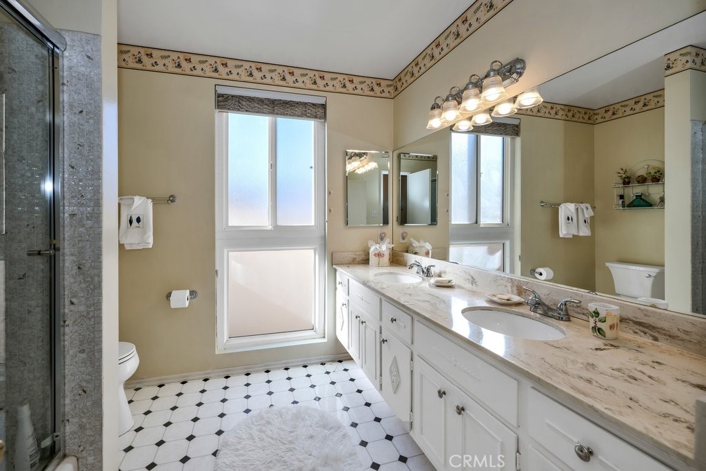 9916 Bothwell Road Northridge, CA 91324 - Photo 24 of 41 a bathroom with a double vanity sink mirror and shower