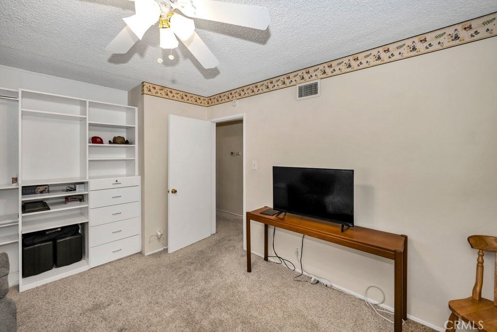 9916 Bothwell Road Northridge, CA 91324 - Photo 27 of 41 a living room with flat screen tv and a ceiling fan