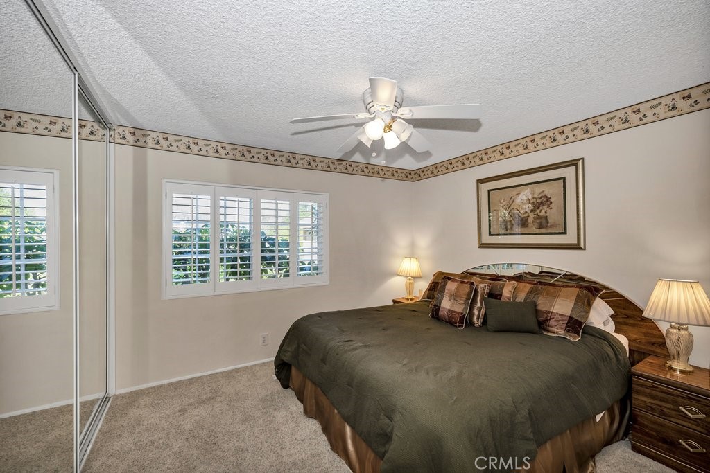 9916 Bothwell Road Northridge, CA 91324 - Photo 29 of 41 a bedroom with a large bed and a chandelier